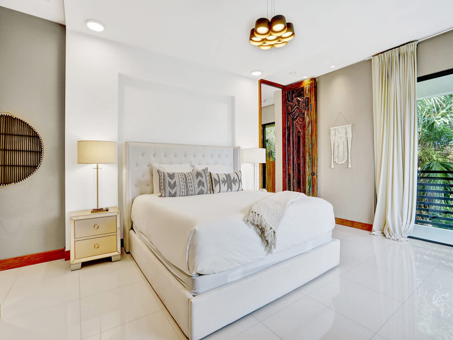 Contemporary bedroom featuring a queen-size bed, modern lighting, and clean minimalist design. Soft neutral finishes, ample storage, and a bright open layout create a comfortable and functional space for relaxing and unwinding.