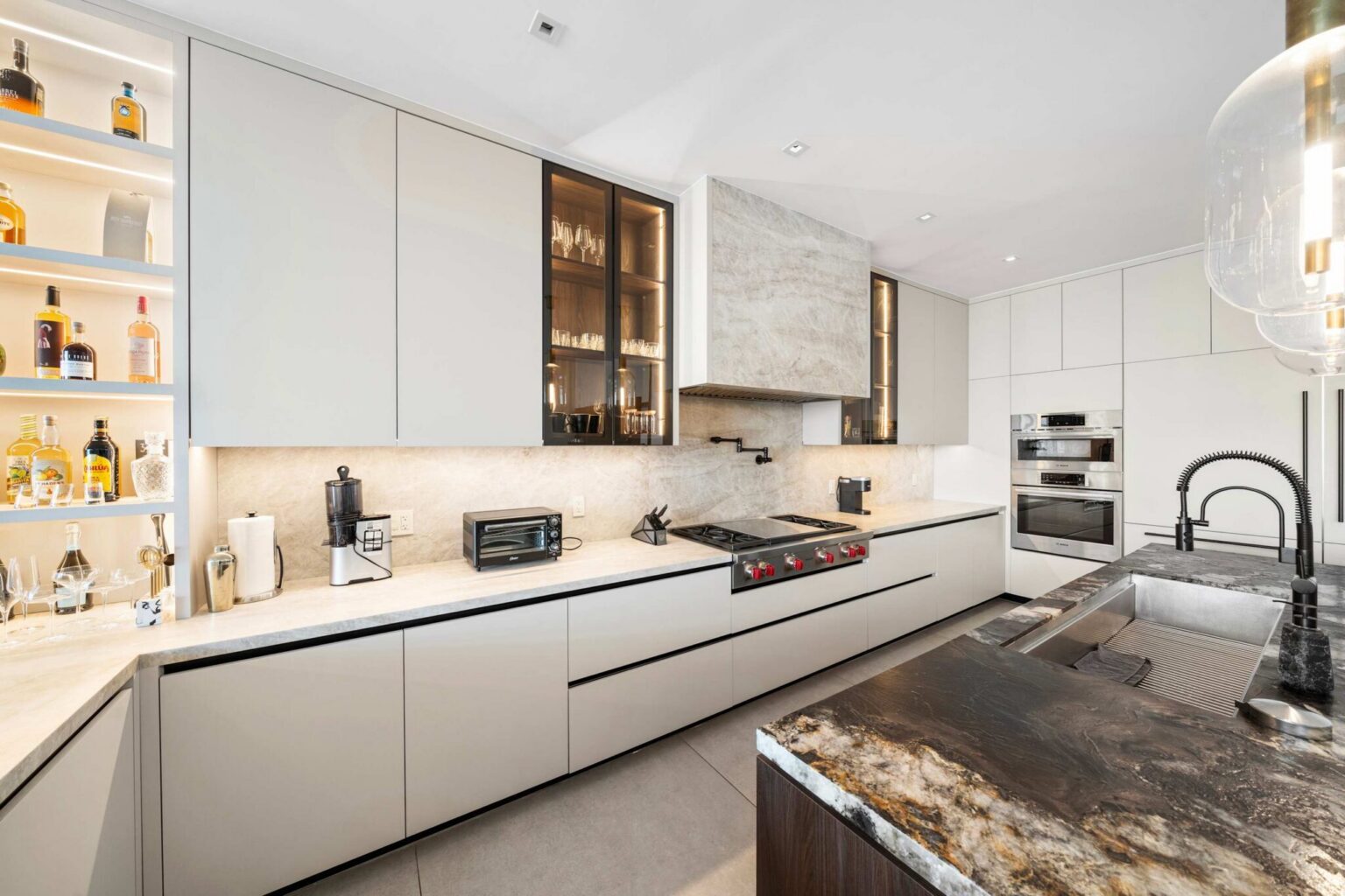 Gourmet kitchen showcasing elegant stone surfaces, custom millwork, and high-end appliances.