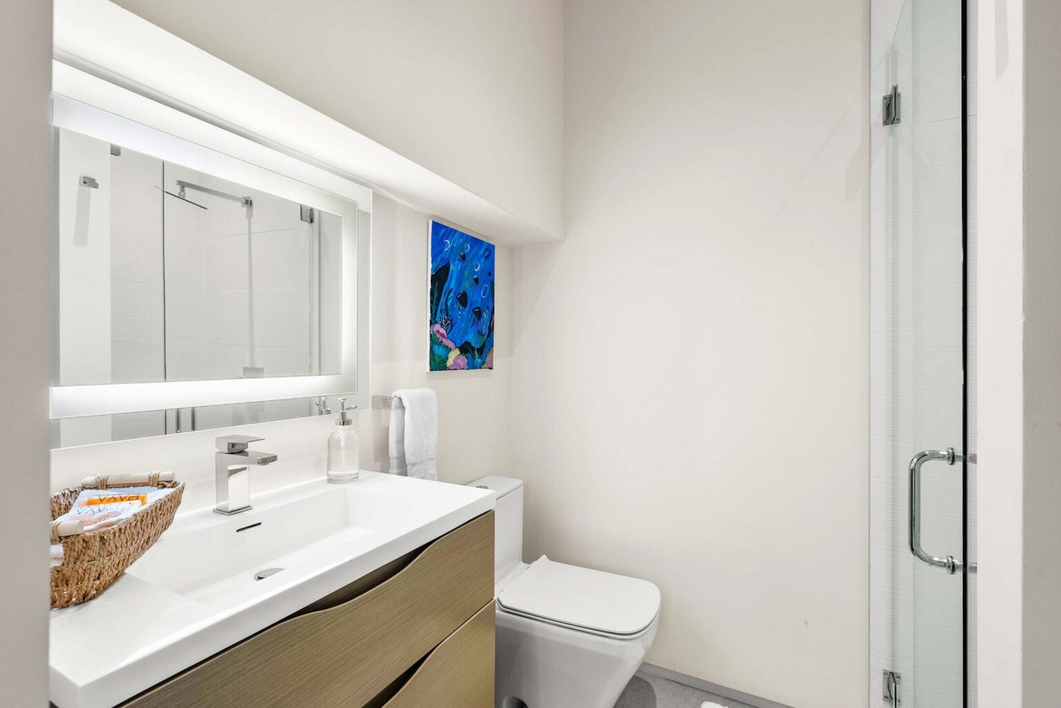 A sleek en-suite bathroom featuring contemporary finishes, custom cabinetry, and a clean, sophisticated aesthetic.