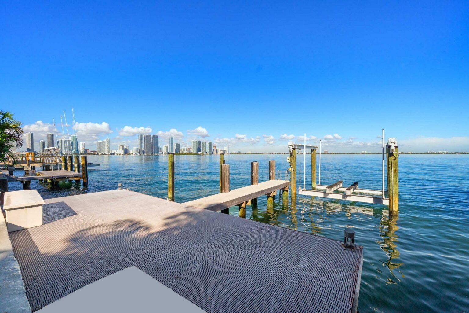 Waterfront dock with direct bay access, boat lift, and panoramic water views. Expansive dock area provides space for boating, fishing, and enjoying unobstructed views of the bay and surrounding skyline.