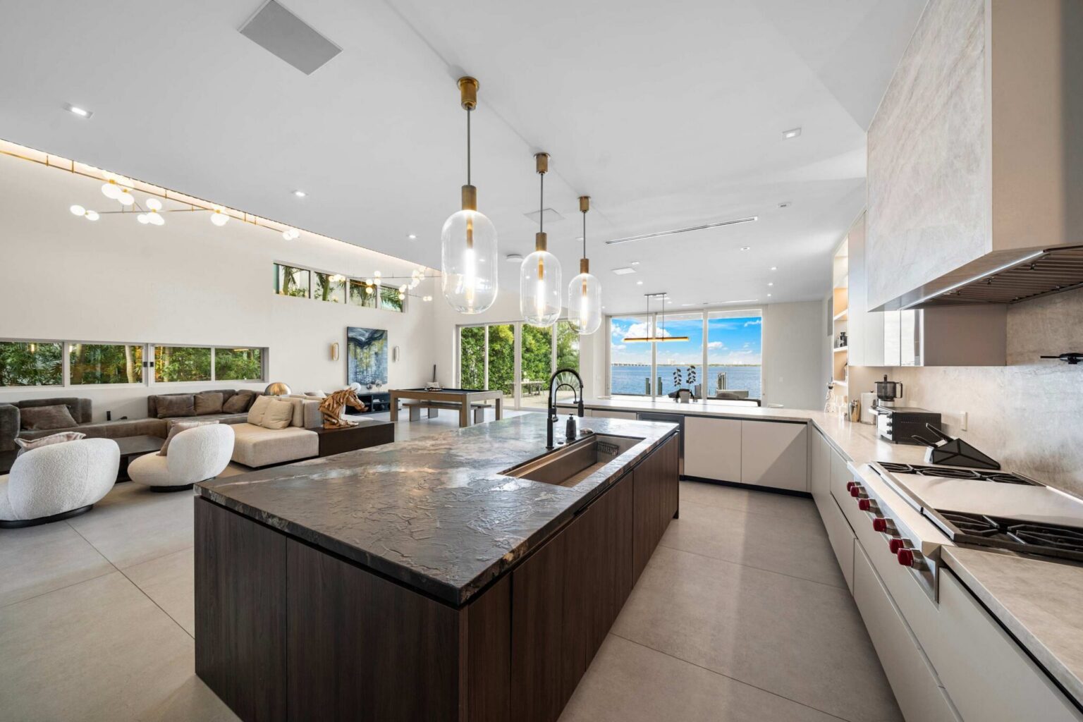 Expansive chef’s kitchen flows seamlessly into elegant living spaces with breathtaking water views.
