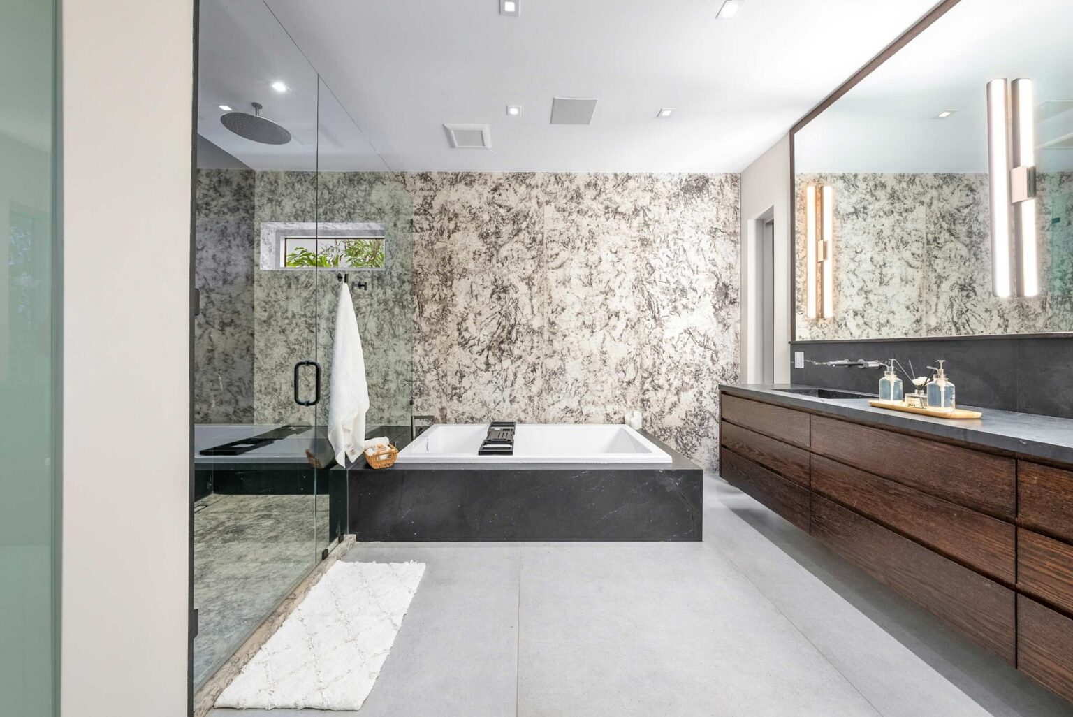 A luxurious escape featuring a deep soaking tub, expansive glass shower, and beautifully curated designer details.