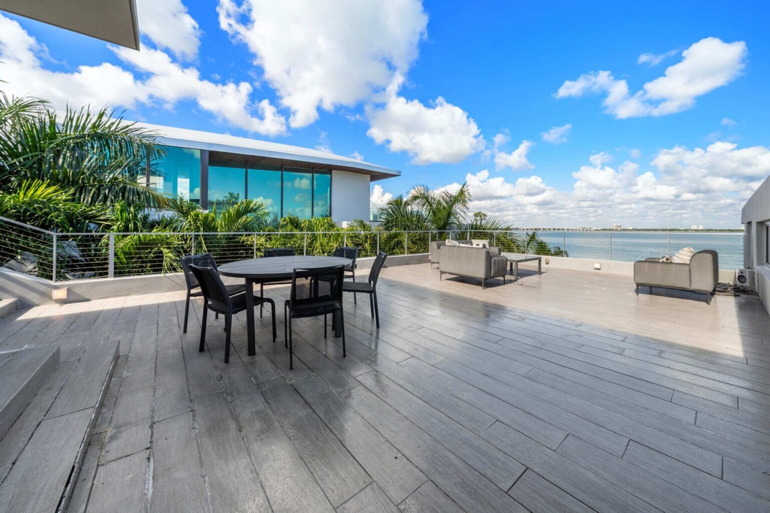 A private outdoor oasis featuring generous entertaining space and stunning waterfront scenery.
