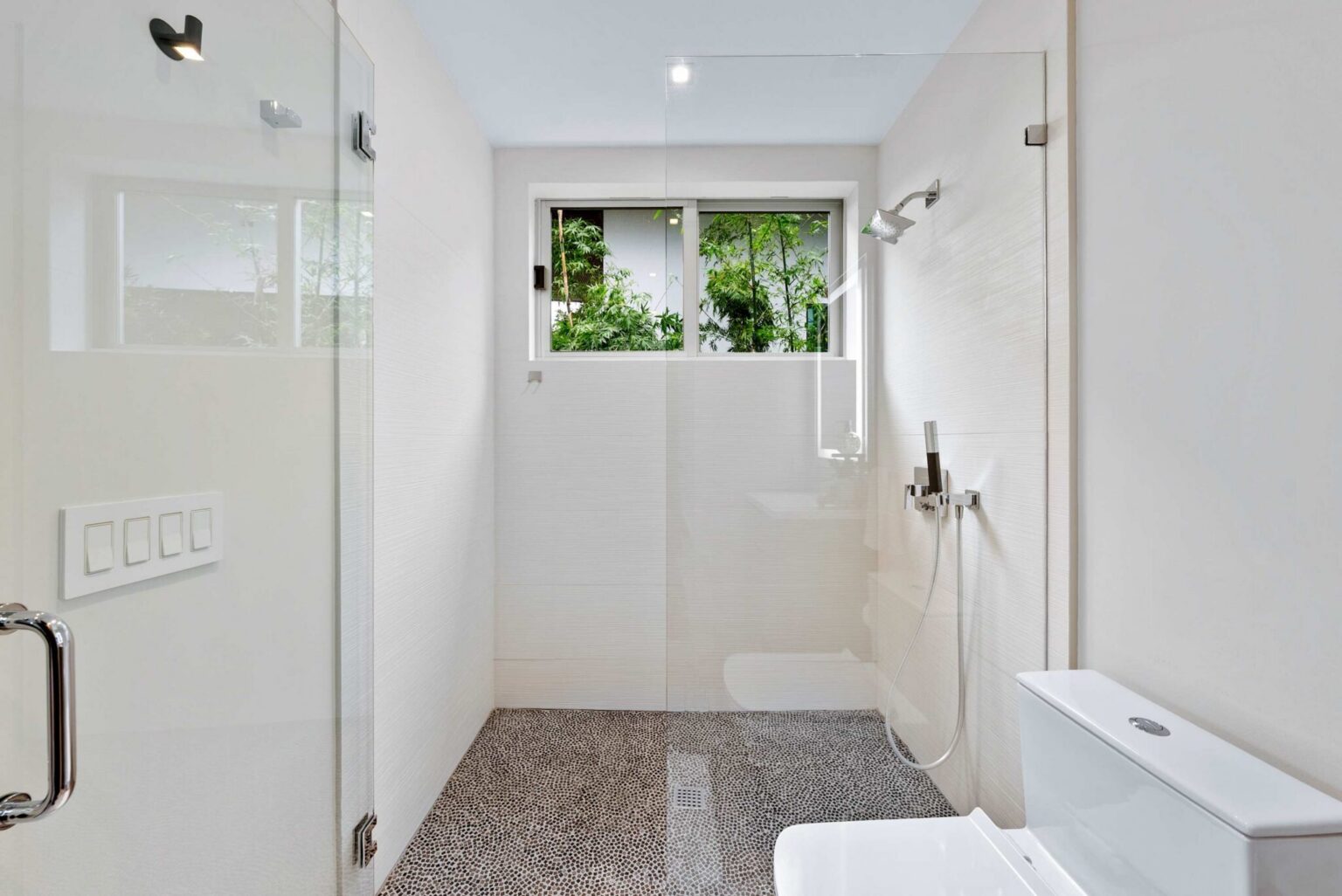 A tranquil escape featuring a spacious walk-in shower, natural light, and refined contemporary finishes.
