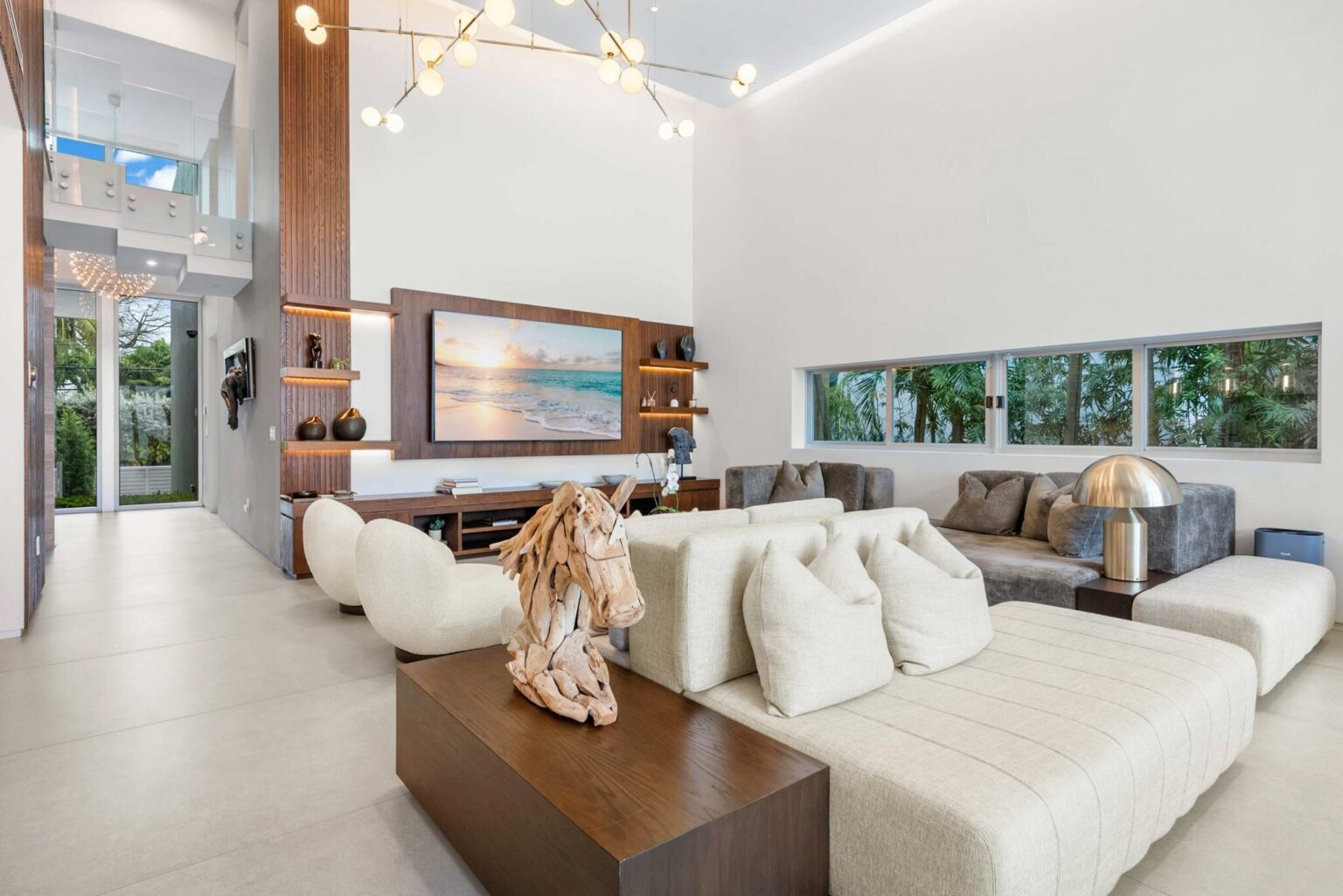 Step into an architecturally stunning retreat where soaring ceilings, designer furnishings, and expansive living spaces create an atmosphere of effortless luxury.