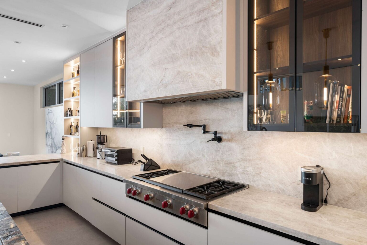 Luxury kitchen showcasing bespoke cabinetry, dramatic stonework, and refined modern elegance.