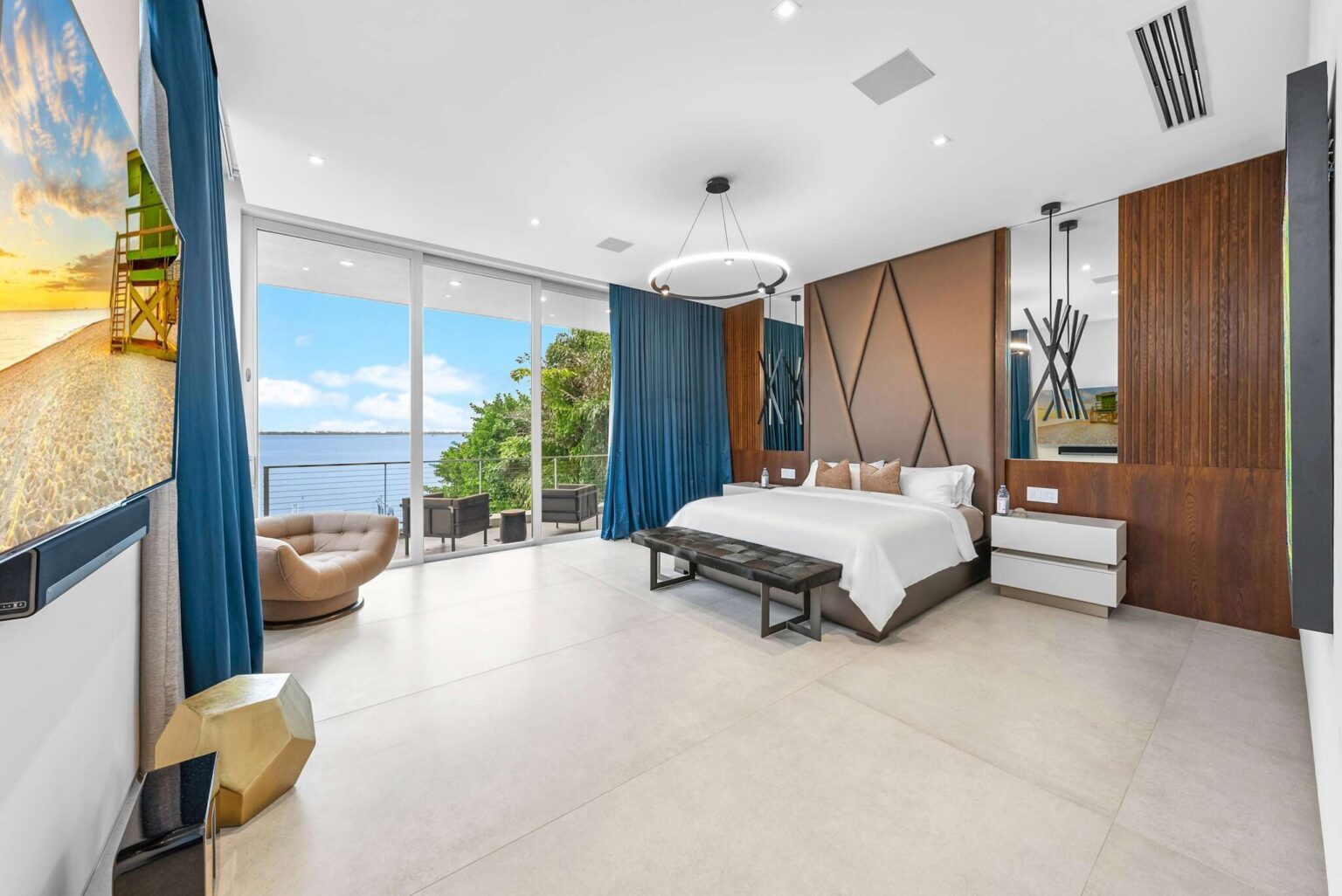 Wake up to breathtaking waterfront views in this spectacular primary suite, where floor-to-ceiling glass and designer finishes create a true luxury retreat.
