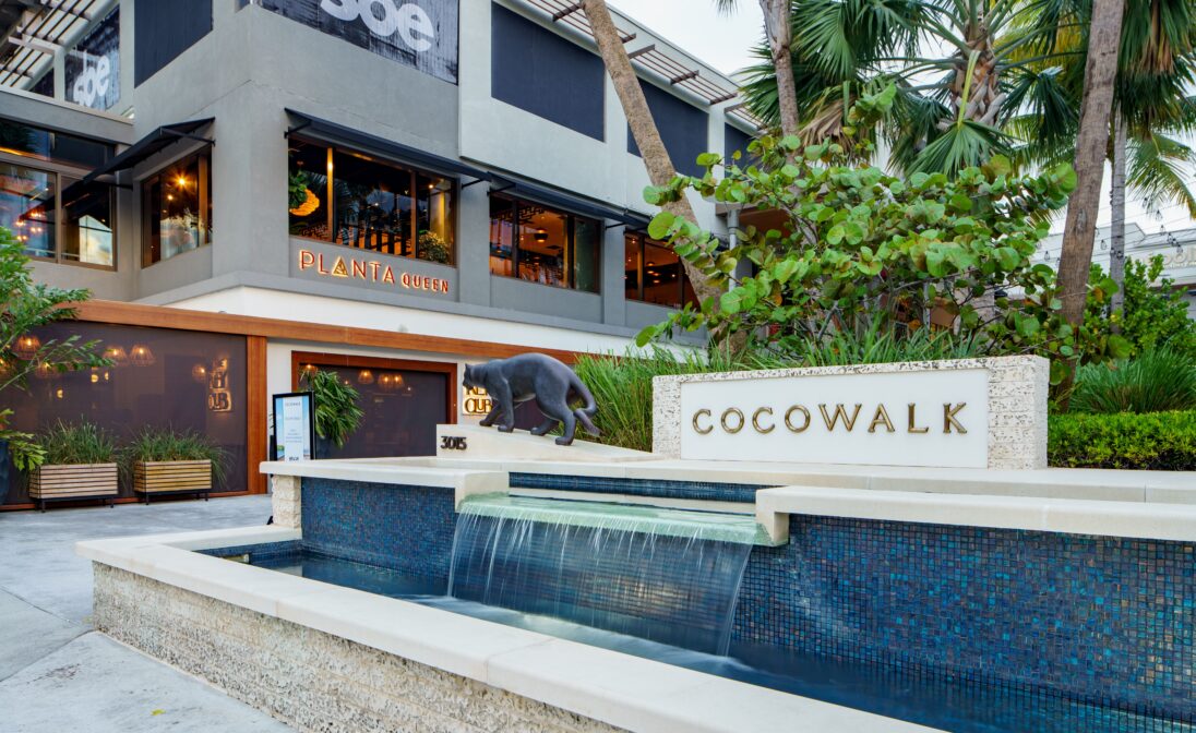 CocoWalk shopping and dining destination in Coconut Grove, Miami, surrounded by tropical landscaping.