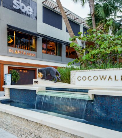 CocoWalk shopping and dining destination in Coconut Grove, Miami, surrounded by tropical landscaping.
