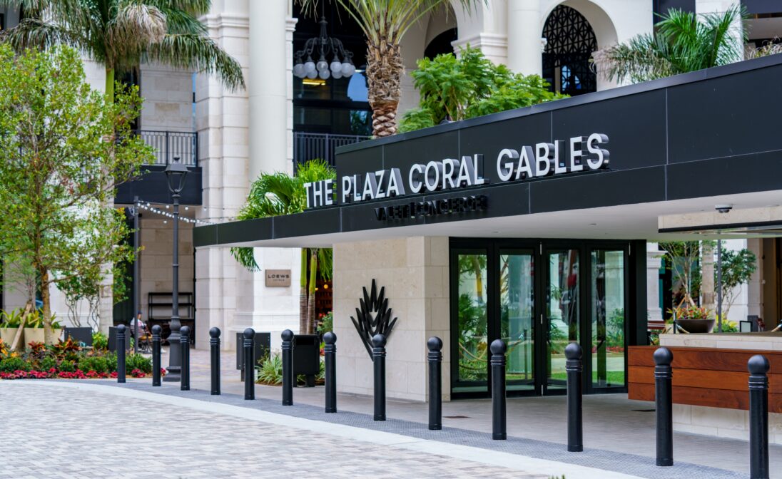 The Plaza Coral Gables entrance surrounded by modern architecture and tropical landscaping in Coral Gables, Miami.