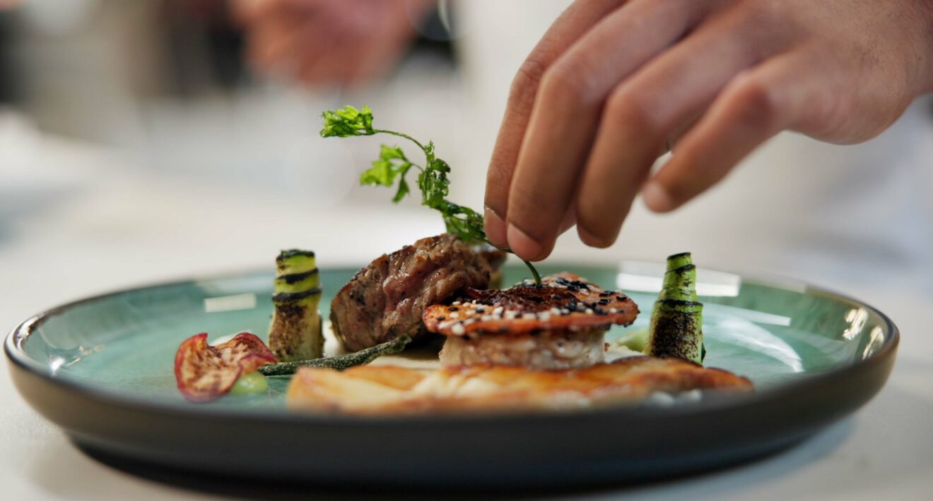 Private chef preparing a gourmet meal in a luxury Miami villa.