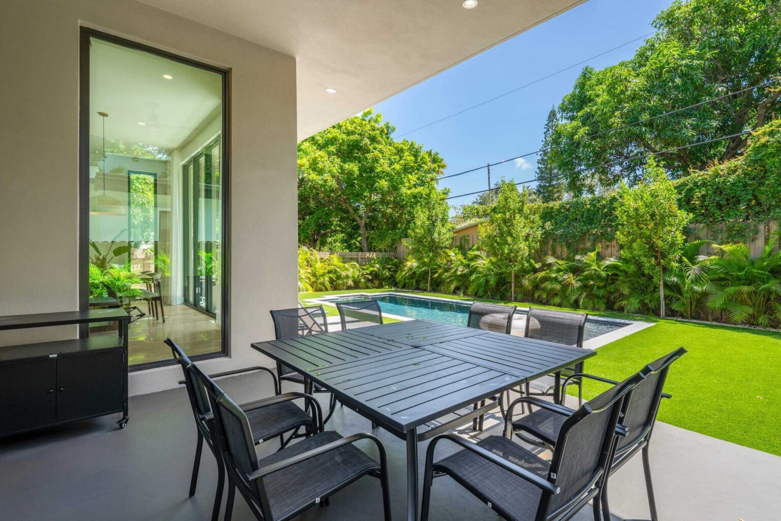 Covered terrace with outdoor dining and grill