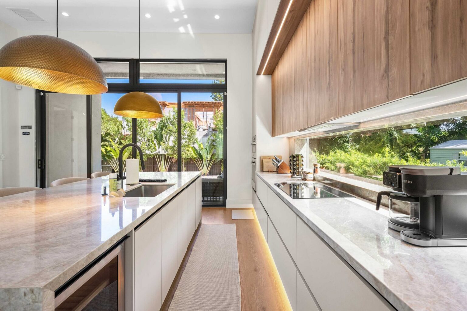 Fully equipped kitchen with coffee station and garden views
