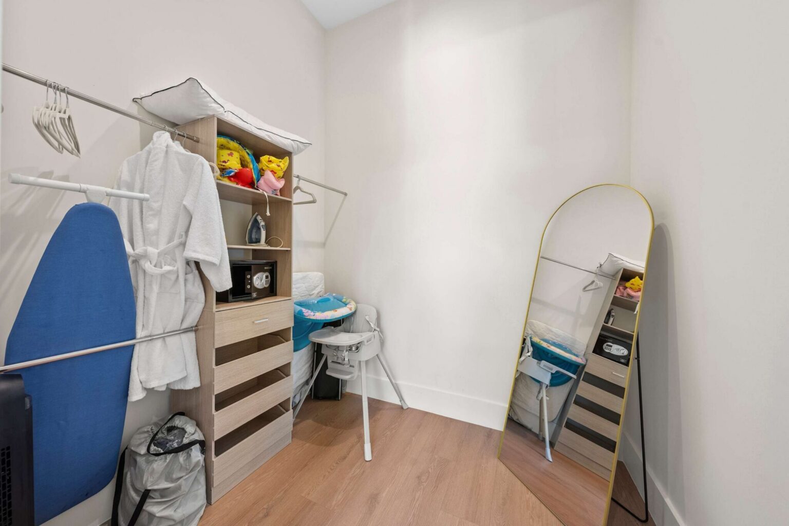 Walk-in closet stocked with robes, iron and family-friendly extras