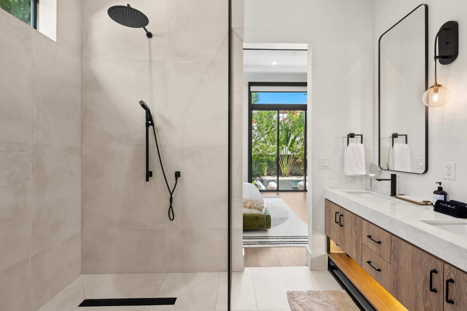 Master ensuite rainfall shower with views through to the pool
