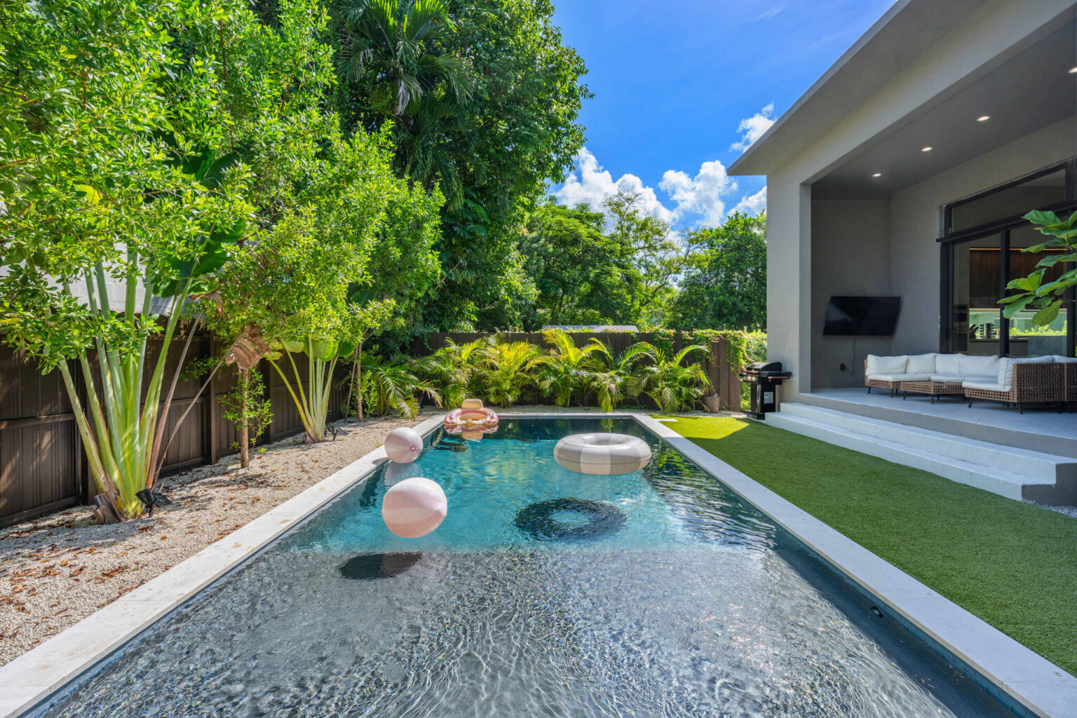 Private pool with floats beside the outdoor lounge and BBQ area