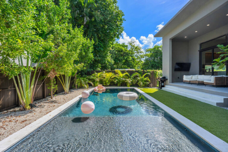 Private pool with floats beside the outdoor lounge and BBQ area