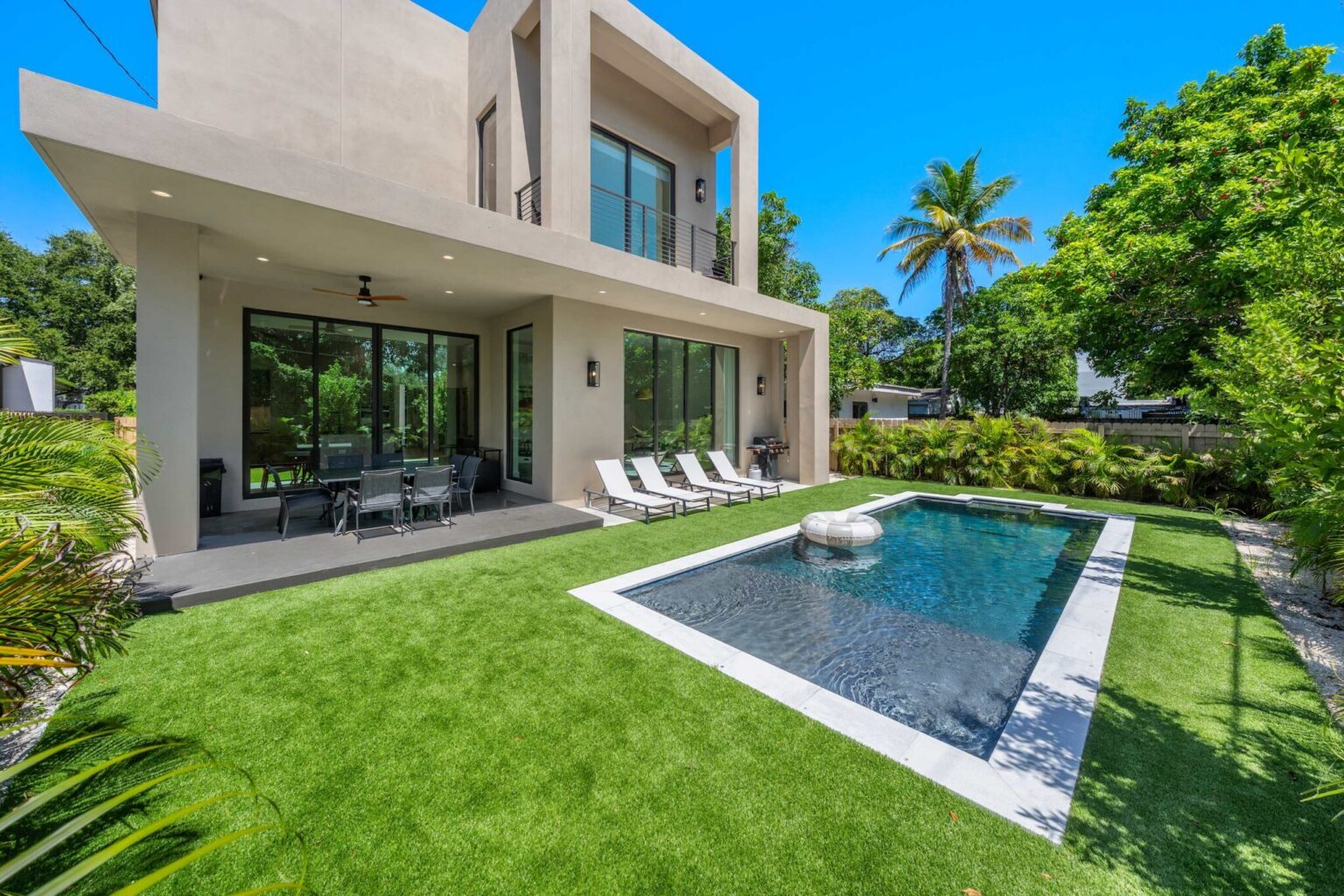 Two-story rear exterior with pool and lawn