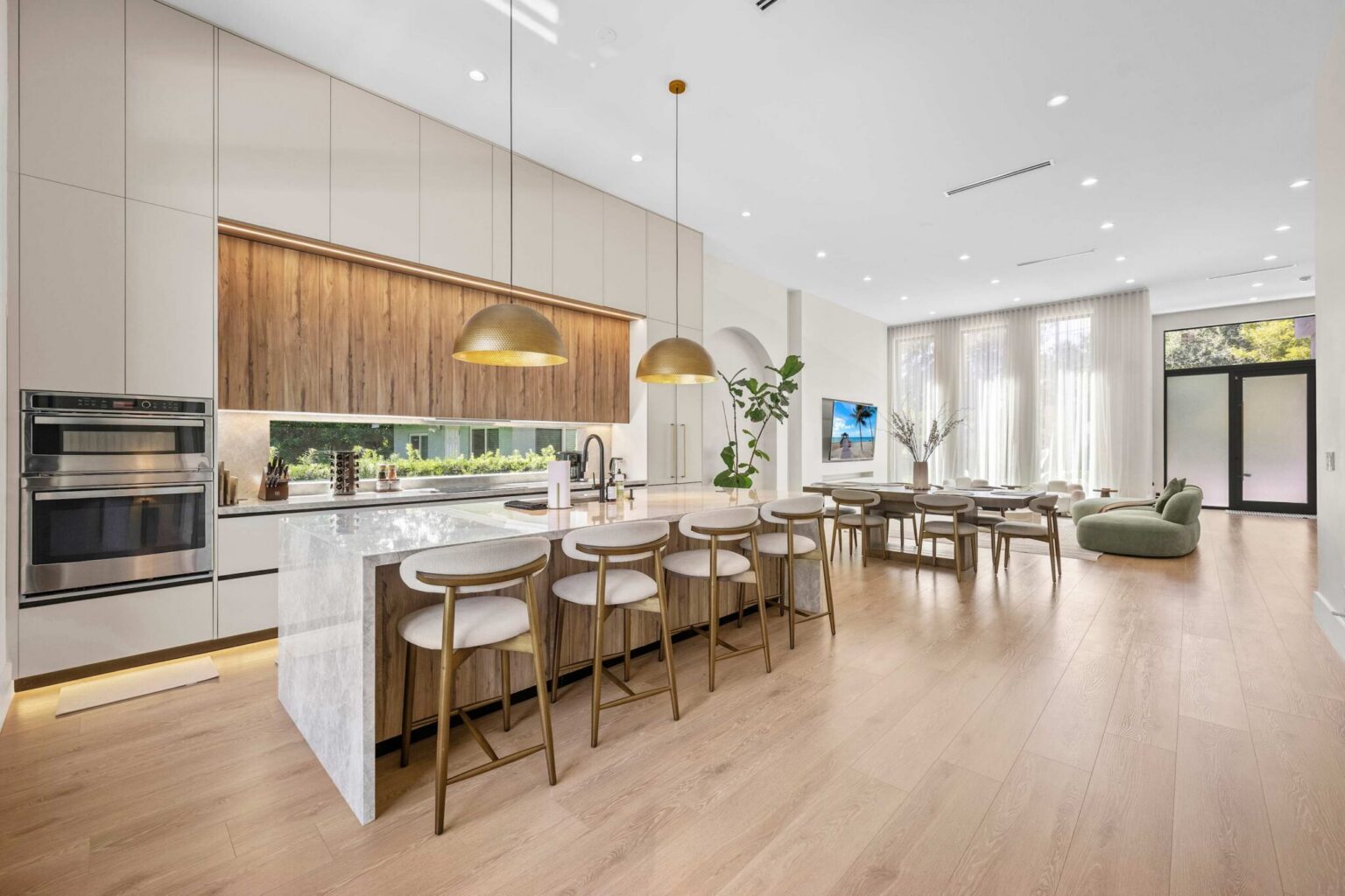 Open-concept kitchen with island seating flowing into the dining area