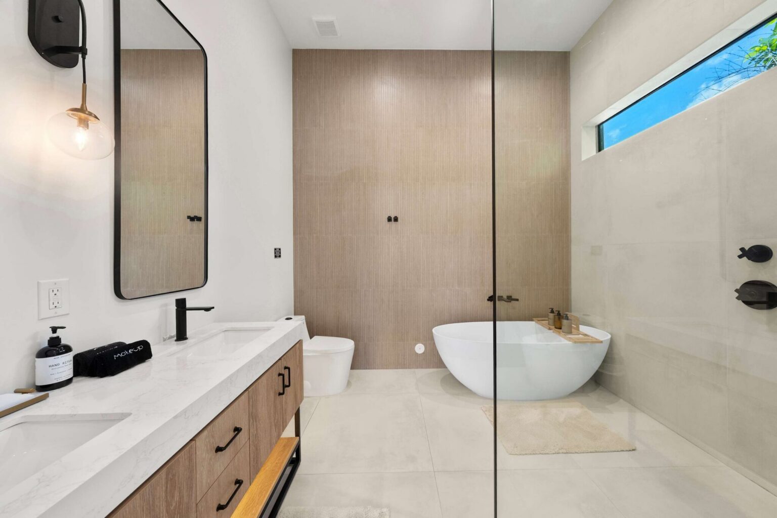 Master bathroom with freestanding tub and wood-look accent wall