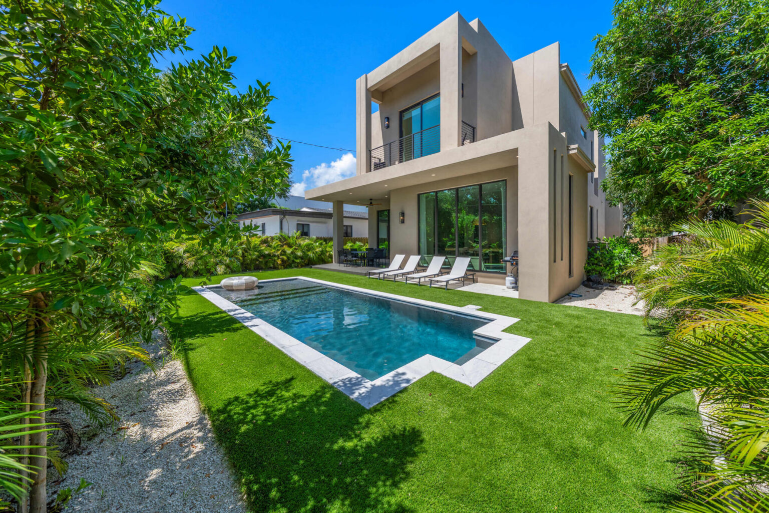 Rear exterior with covered terrace and pool